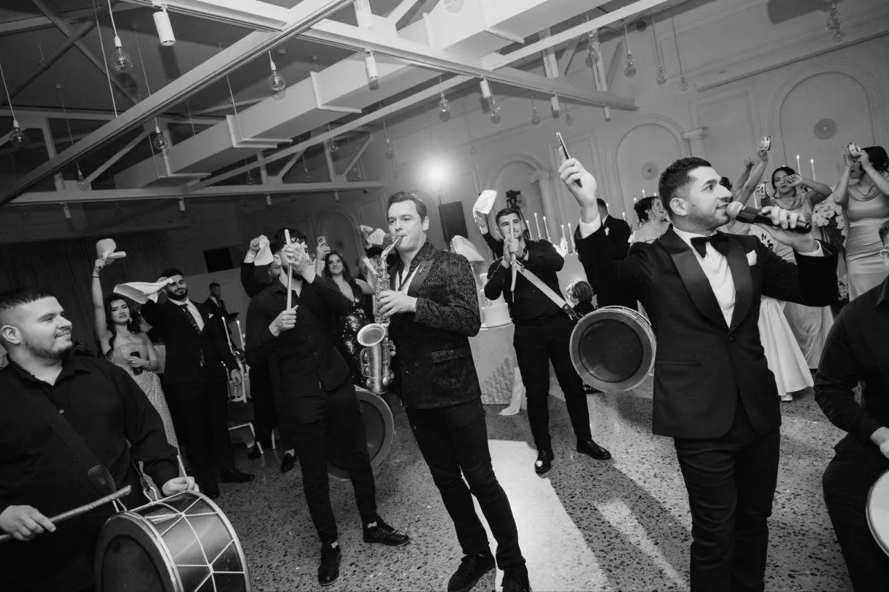 Live band and saxophone filling a packed Sydney dance floor